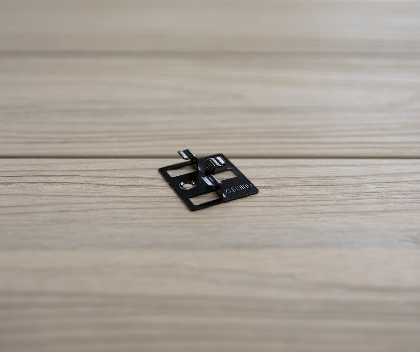 A small black square on top of a wooden table.
