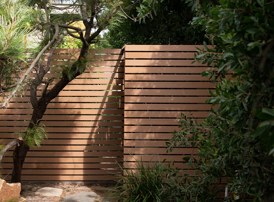 tree with timber fence screening