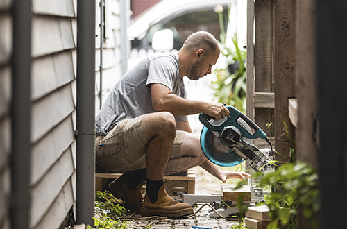 A man working with a circular saw.