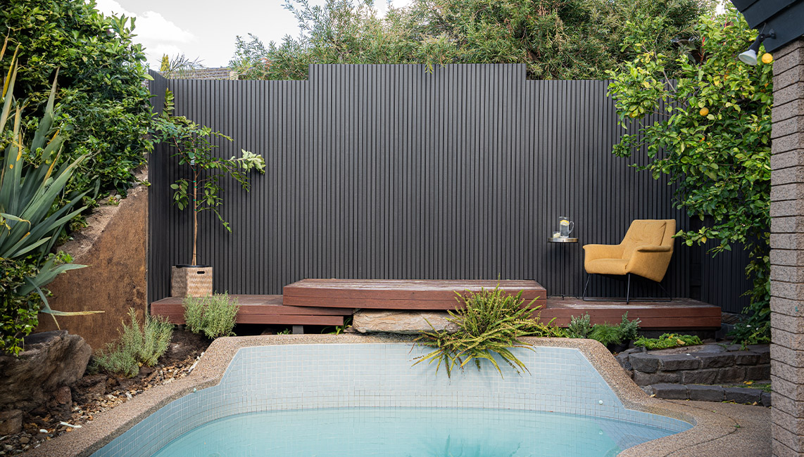 Ekodeck Castellated Panel in carbon fence by swimming pool