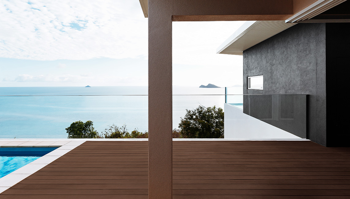 A wooden deck with a view of the ocean.