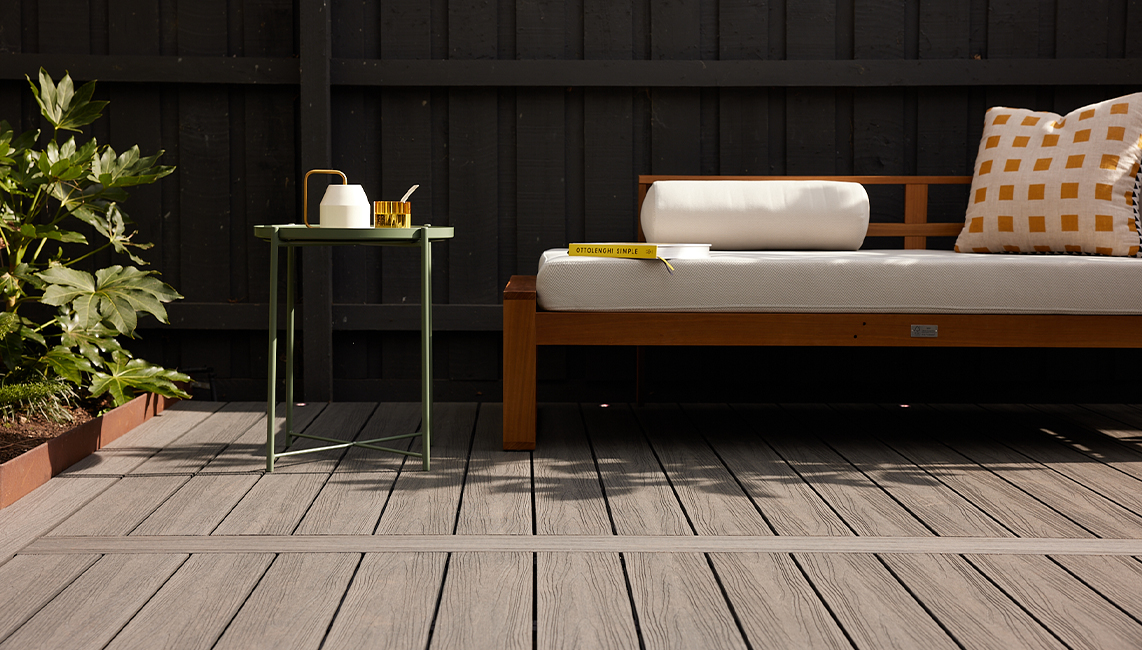 A wooden bench on a wooden deck.